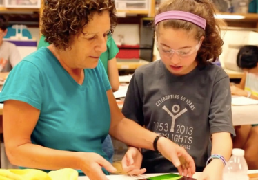 Teacher and student working in art glass studio