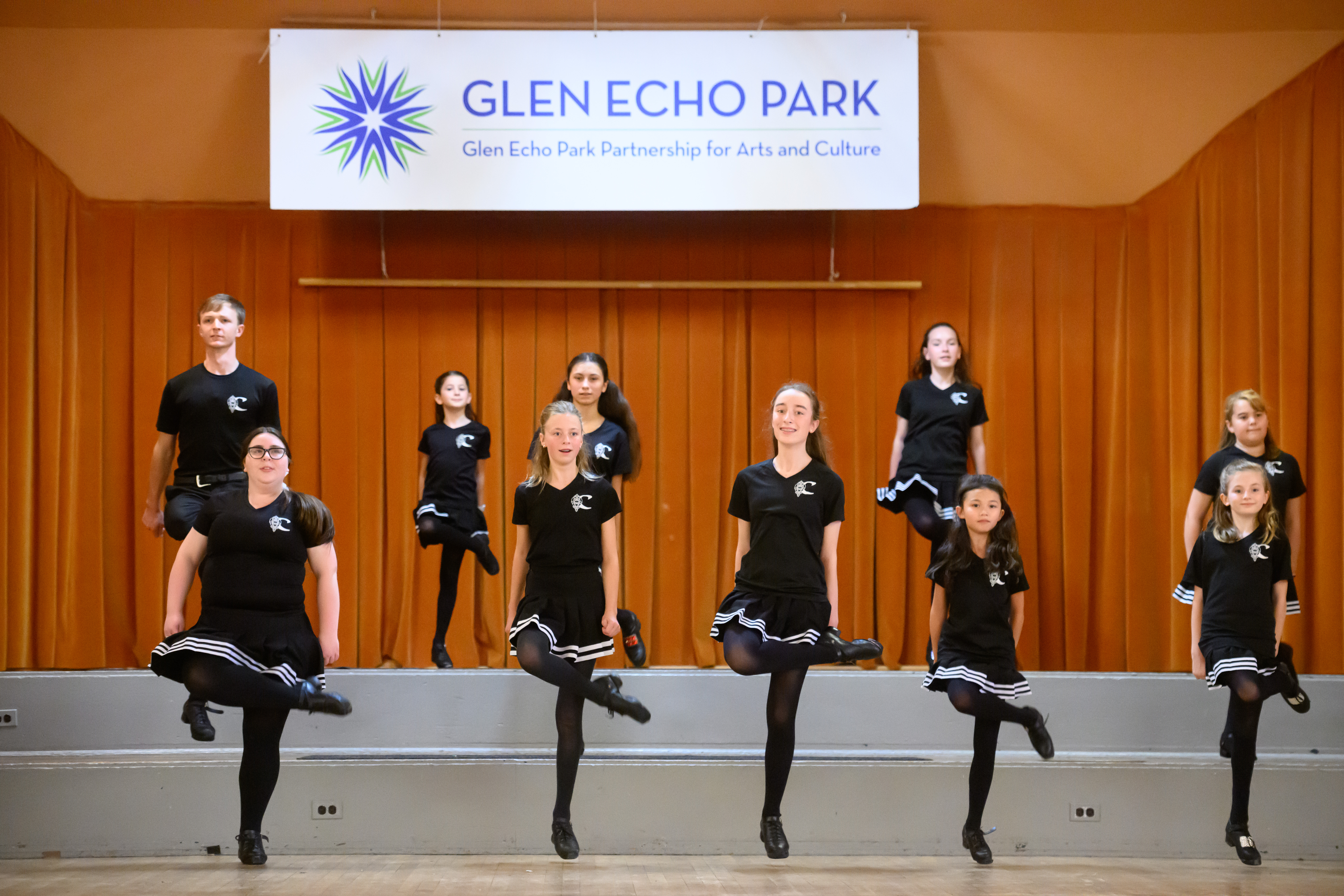 Irish dancers perform on a stage