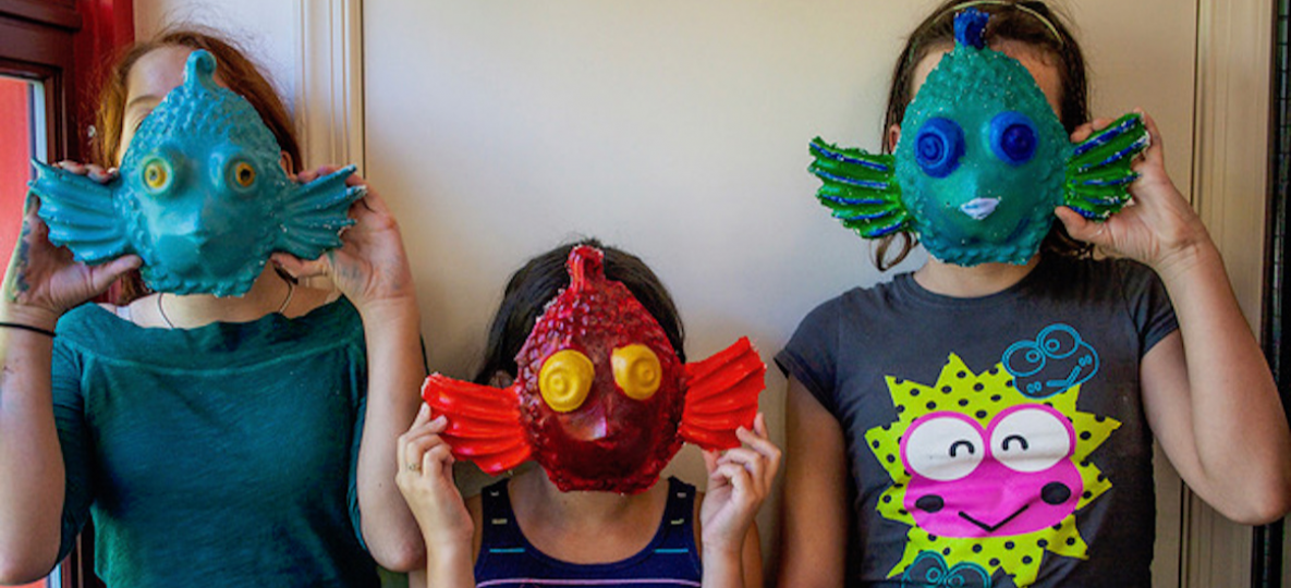 Kids in Young Creative Spirit fine arts camp with colorful masks that they made.
