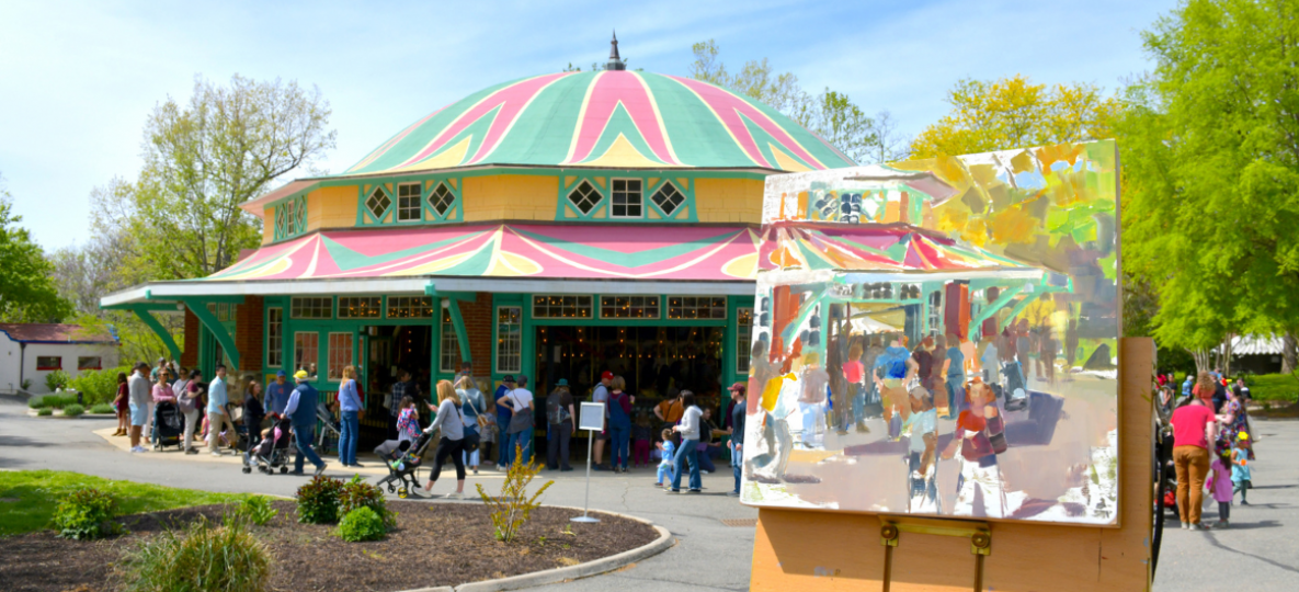 Painting of carousel in front of real carousel